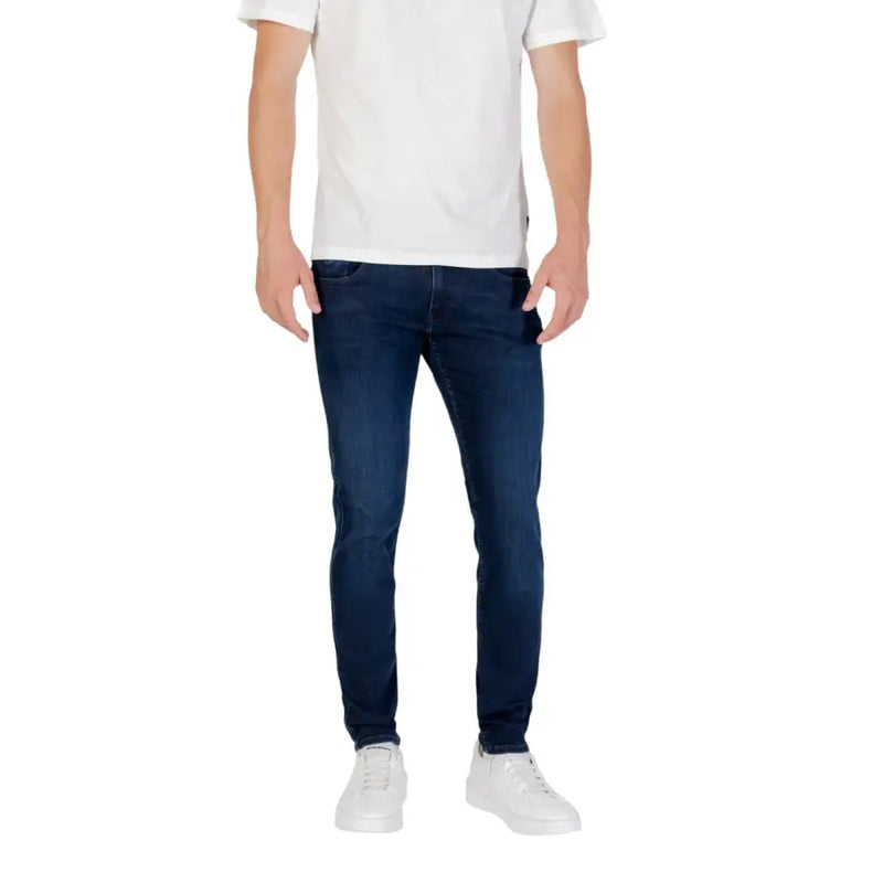 Mens dark blue slim fit denim jeans with a classic five pocket design and subtle fading along the thighs