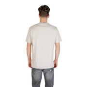 A man wearing a mens light colored off-white short-sleeved t shirt with a subtle crew neckline and no logos
