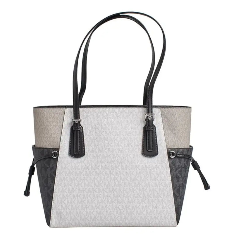 Michael Kors black slip on handbag tote with light gray and black two tone panels and signature monogram pattern