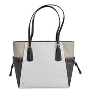 Michael Kors black slip on handbag tote with light gray and black two tone panels and signature monogram pattern