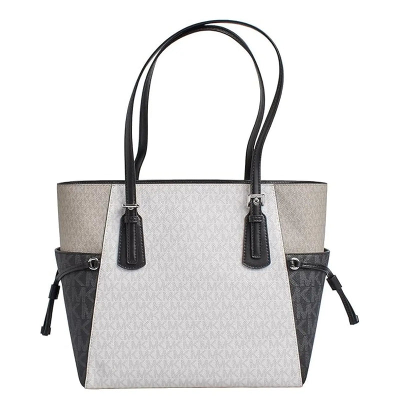 Michael Kors black slip on handbag tote with light gray and black two tone panels and signature monogram pattern