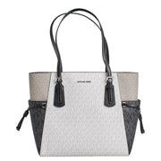 Michael kors black slip on tote bag with white and gray monogram pattern black leather trim and side pockets with drawstrings