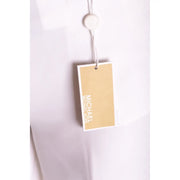 A beige michael kors brand tag with white lettering attached to white stretch womens zip button trousers