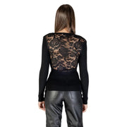 Woman wearing Morgan De Toi black long knit sweater with lace back and leather pants