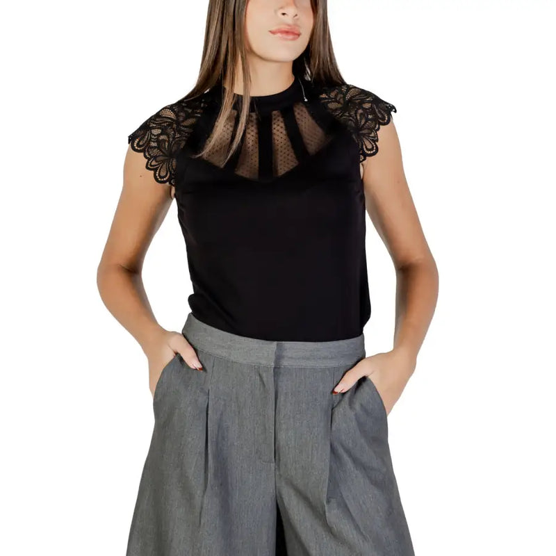 Morgan de Toi black sleeveless turtleneck blouse with delicate lace shoulders and sheer mesh panel at the neckline