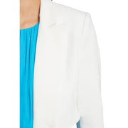 White tailored blazer with clean lines worn over bright blue top from Morgan De Toi spring summer collection