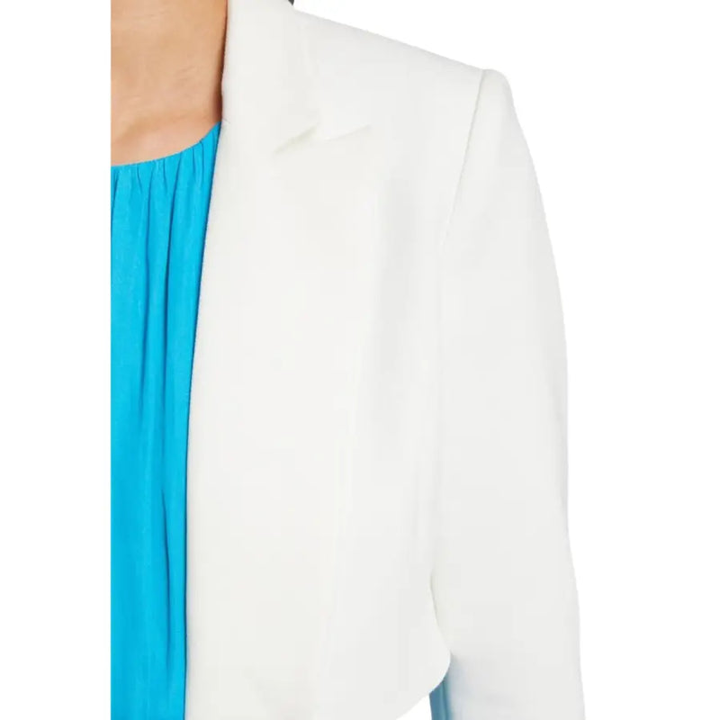 White tailored blazer with clean lines worn over bright blue top from Morgan De Toi spring summer collection