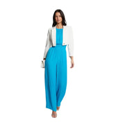 A woman wears a Morgan De Toi white long cropped blazer paired with a turquoise wide-leg jumpsuit for spring summer