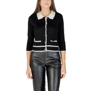 Woman wearing Morgan De Toi black cardigan with white collar and leather pants
