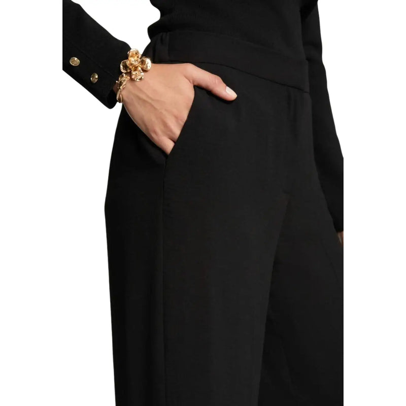 Gold floral bracelet with intricate detailing worn with morgan de toi women black polyester trousers with pockets