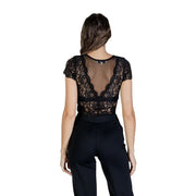 Woman wearing Morgan De Toi black lace short-sleeve blouse with sheer back and v-neckline