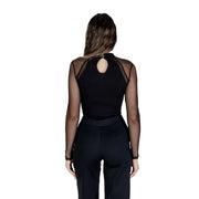 Back view of Morgan de toi women black viscose blouse long sleeve with mesh and back cutout paired with solid pants