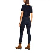 Dark blue skinny jeans with a brown leather belt loop and subtle stitching details paired with morgan de toi blue v neck polyester t shirt plain short