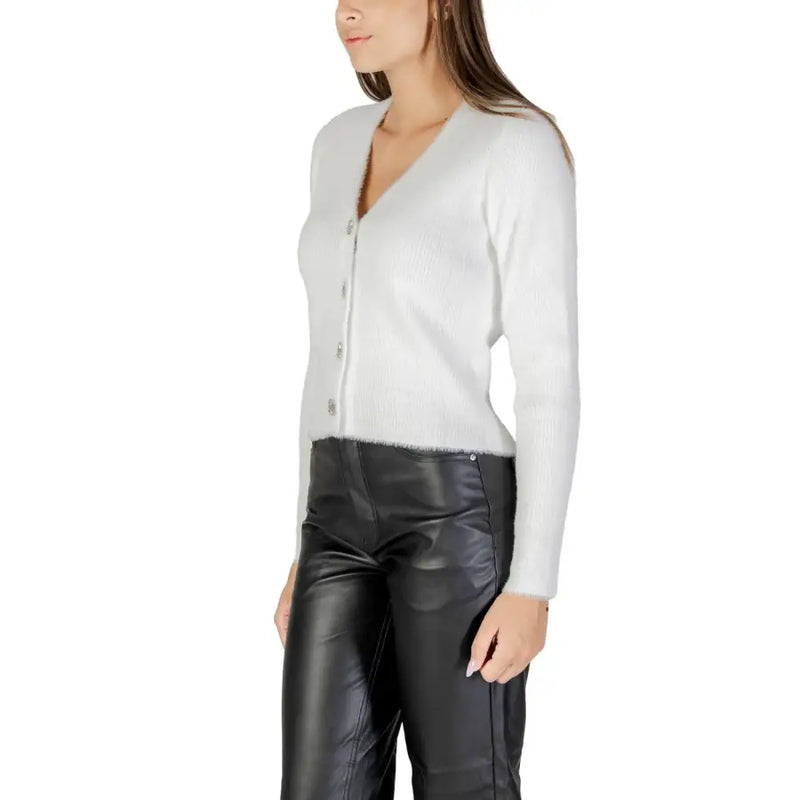 Women wearing Morgan De Toi white V-neck button-up cardigan with black leather pants