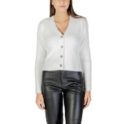 Women wearing Morgan De Toi white fuzzy V-neck cardigan with black faux leather pants