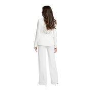 White blazer with intricate beaded back detailing paired with morgan de toi women white wide-leg trousers with zip front pockets viewed from back