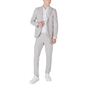Mulish men grey slim fit suit in polyester viscose blend worn over white dress shirt with white sneakers