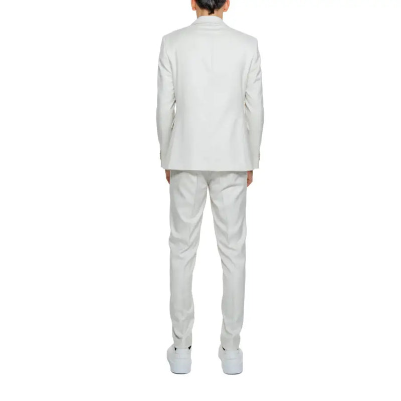 A crisp white tailored suit with a structured blazer and matching trousers made from smooth polyester viscose blend fabric