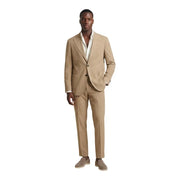 Beige two-piece suit with single-breasted jacket and matching trousers in subtle textured tailored fit polyester