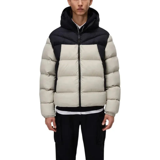 Beige and black down jacket with hood, zipper closure.