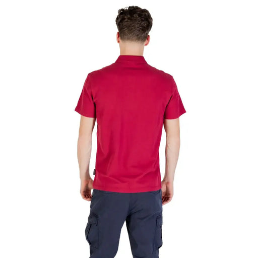 Red polo shirt with short sleeves and navy cargo pants.