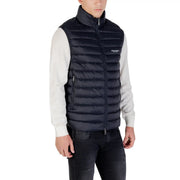 Black quilted puffer vest with high collar and front zipper featuring Armani Exchange logo on chest in navy blue puffer vest product