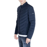 Navy blue quilted puffer jacket displayed on a model showcasing warmth and style