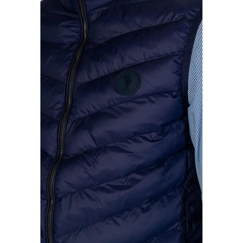 Navy blue quilted puffer vest displayed on a mannequin for men’s outerwear fashion