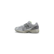New Balance men 1906r grey synthetic lace up sneakers with mesh and lime green heel detail shown from the back