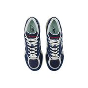 New Balance men grey leather suede sneakers with navy blue and white mesh uppers and red branding accents