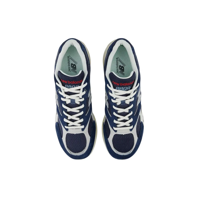 New Balance men grey leather suede sneakers with navy blue and white mesh uppers and red branding accents
