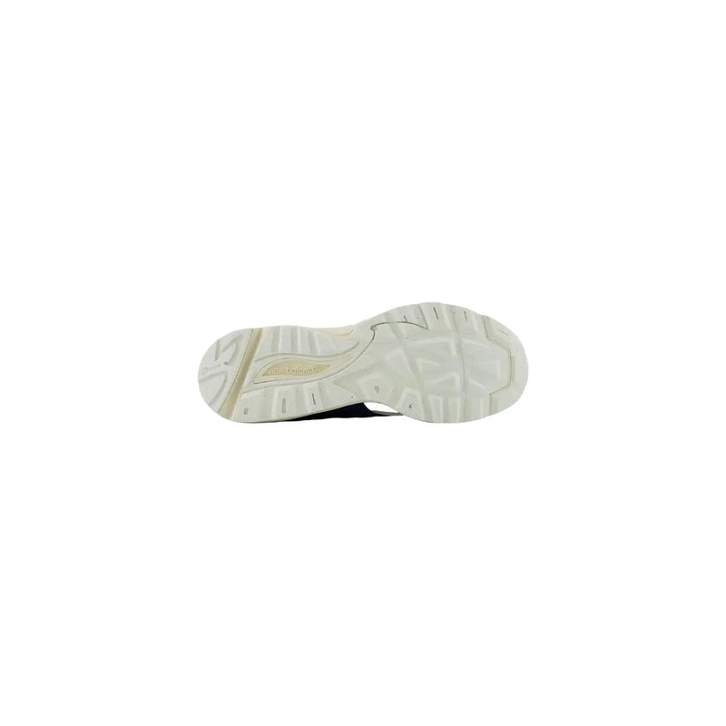 New Balance men grey leather suede sneakers featuring a white rubber sole with a textured tread and skechers gold logo