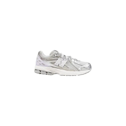 Silver new balance running shoe with mesh upper and rubber sole.