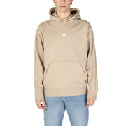 Men’s beige hooded sweatshirt with front pouch pocket from New Balance featuring a turtleneck style