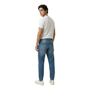 New balance men t-shirt paired with blue denim jeans featuring classic five-pocket design and subtle fading