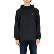 Men’s black hooded windbreaker jacket with full-zip front and elastic cuffs paired with dark blue jeans