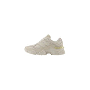 New Balance women beige suede sneakers with mesh upper, chunky rubber sole, and translucent yellow heel accent