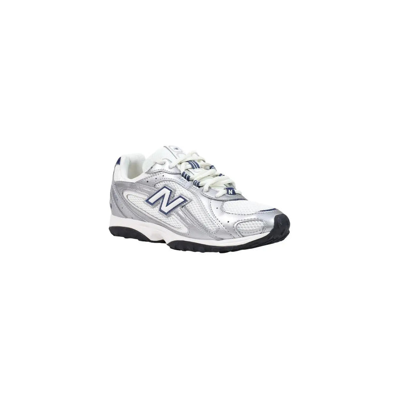 New Balance women blue slip on synthetic sneakers with silver and white mesh upper, black sole, and navy blue logo accents