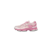 New balance women pink suede sneakers with chunky layered sole in pink and white color scheme displayed from the back side