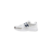 New Balance women’s white synthetic sneakers with silver accents and navy branding