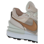 Nike women’s pink slip-on sneakers with a beige and tan colorway and a layered chunky sole design