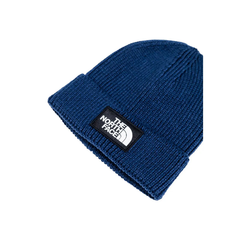 The North Face cap ribbed knit beanie for men in deep blue with black patch and white logo, front view