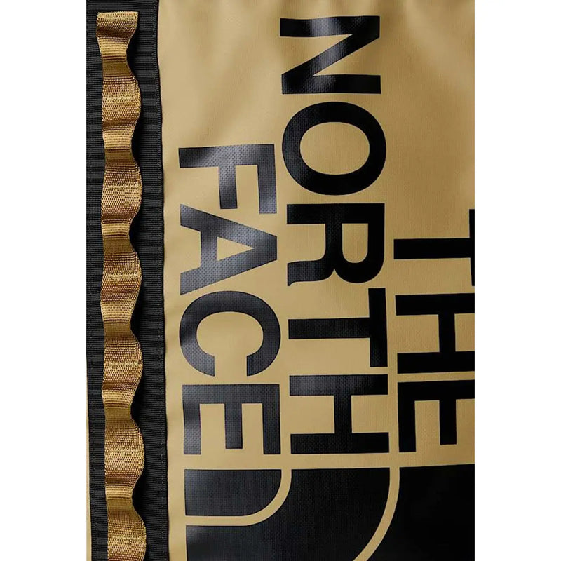 The north face men beige print rucksack with gold color black lettering and wavy gold trim along the side
