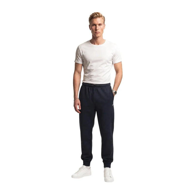 The north face men black cotton fleece jogger trousers in navy blue with elastic waistband and ribbed cuffs