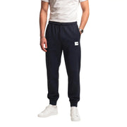 The north face men black cotton fleece trousers in dark navy blue with a white logo patch on the left thigh