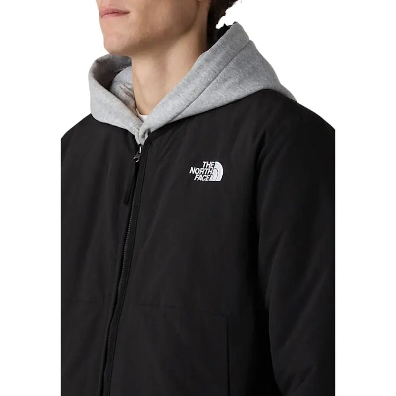 The North Face Herrenblazer, schwarze, lange Nylonjacke mit Reißverschluss, grauer Kapuze und weißem Logo auf der Vorderseite