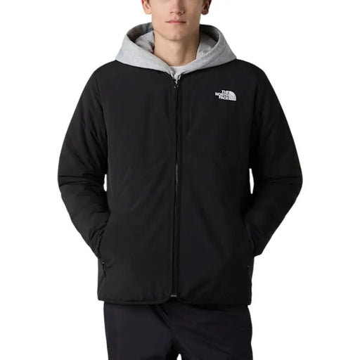 The North Face men blazer black zip long nylon jacket features a black hood with gray-lined interior and chest logo