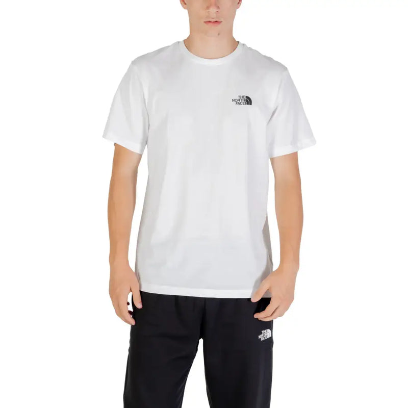 White short-sleeve T-shirt with black logo paired with black athletic pants