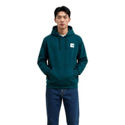 Der grüne Baumwoll-Hoodie von The North Face für Herren besticht durch seine dunkelgrüne Farbe und den weißen Logo-Aufnäher auf der Brust.