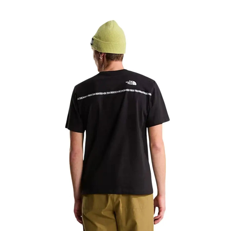 The back side of a black short-sleeved The North Face men t-shirt with white text and logo branding